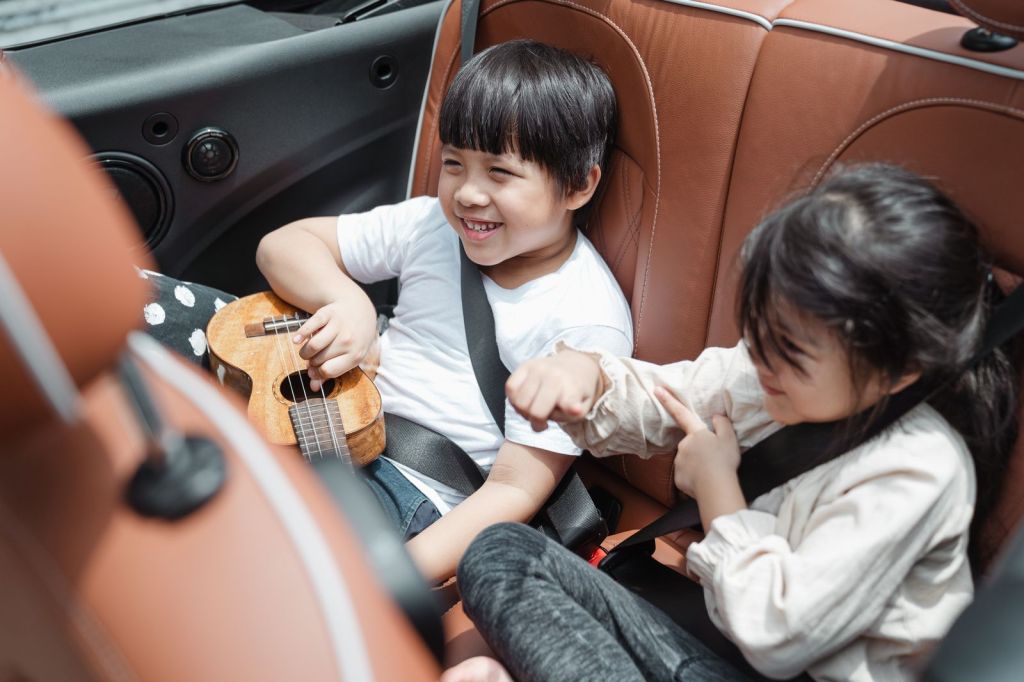 Two smiling children sitting in their seats