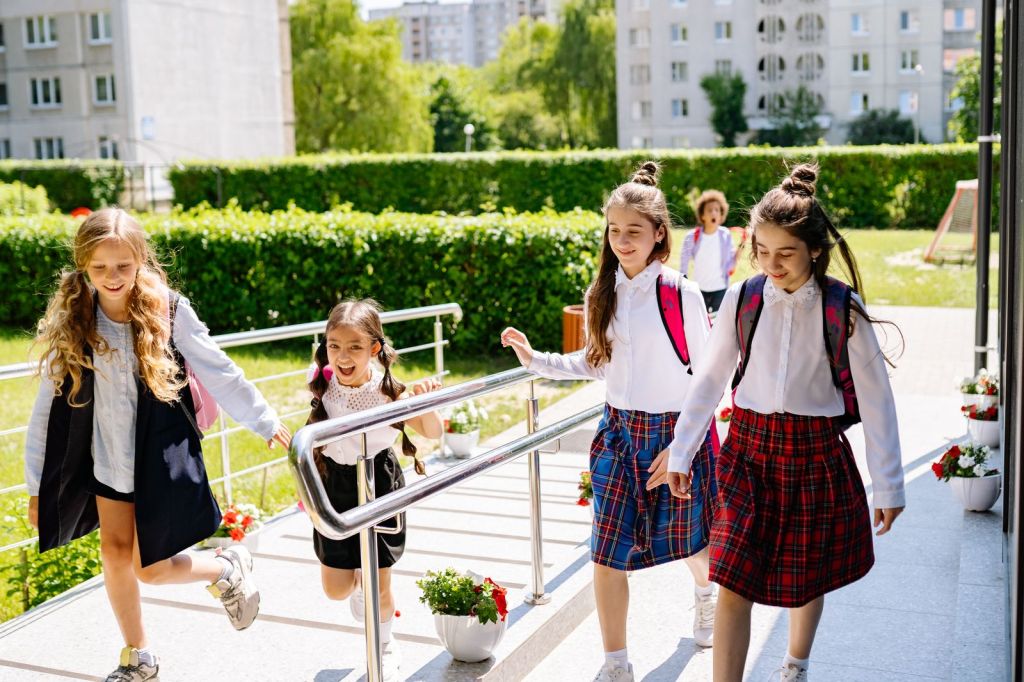 A group of happy kids with backpacks heading to school